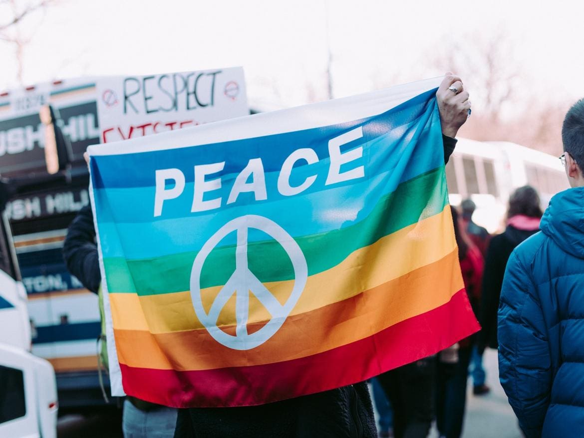 a group of people holding up a peace flag