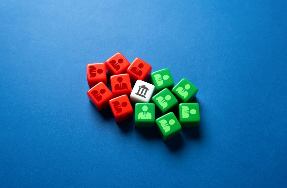 Red, green, and white dice on a blue background illustrating a government shutdown.
