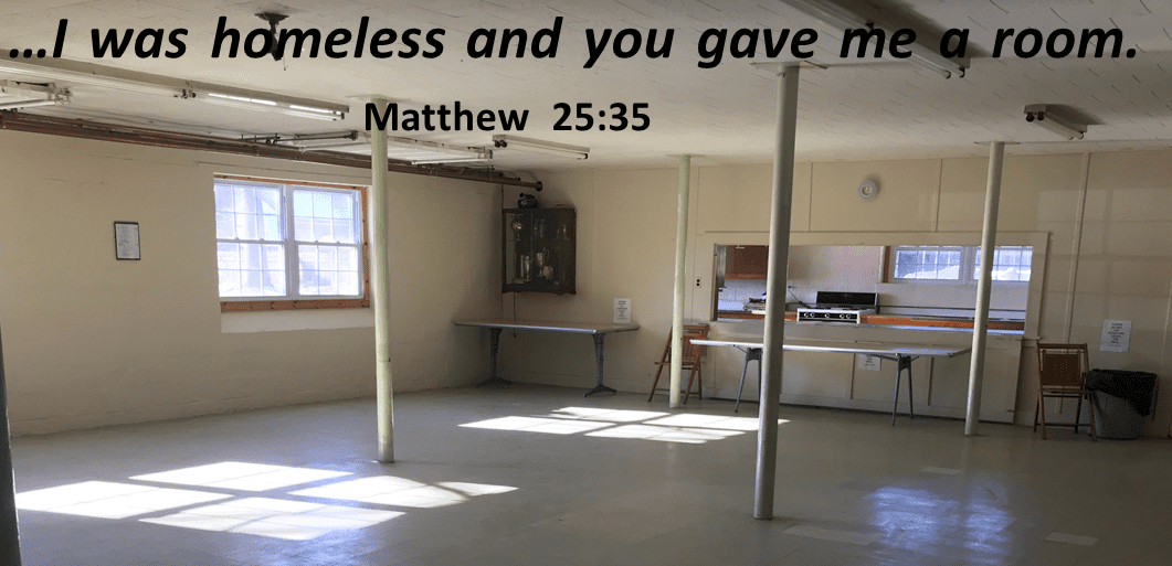 A modest community room with a quote from matthew 25:35 on the wall, suggesting it may be used for charitable purposes.