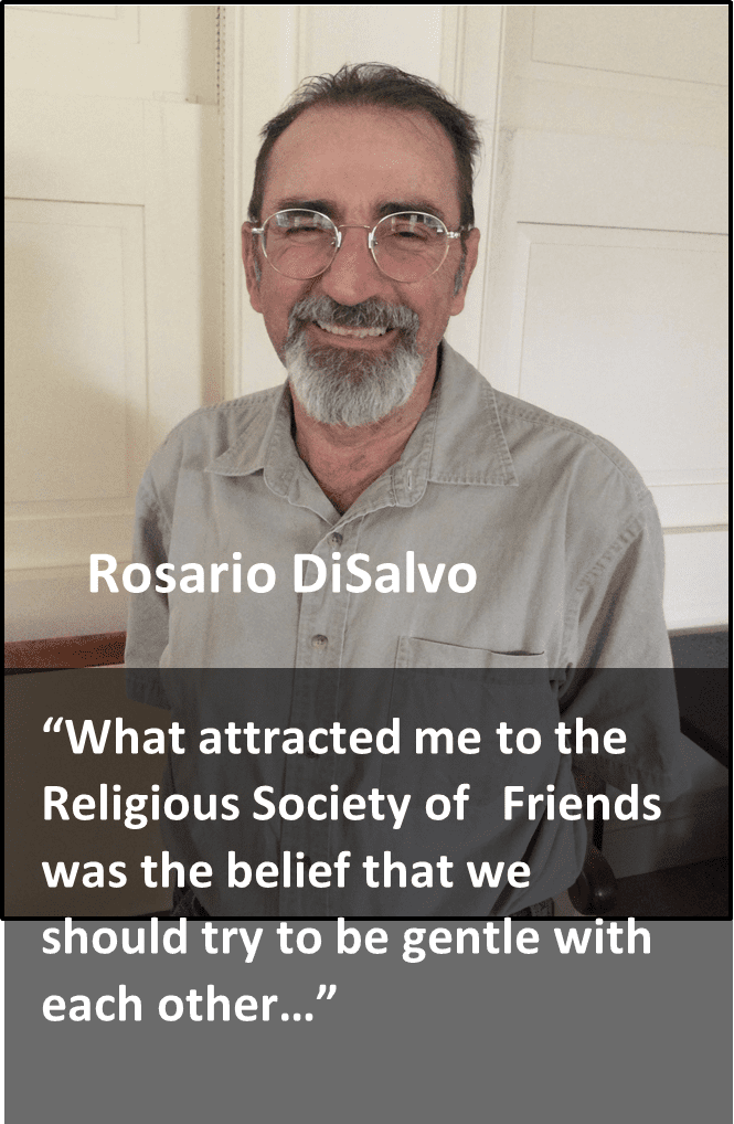 Man sitting indoors smiling at the camera with a quote about his attraction to the religious society of friends.